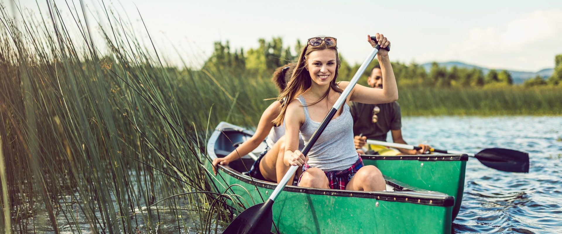 Young Woman Canoeing on the Lake